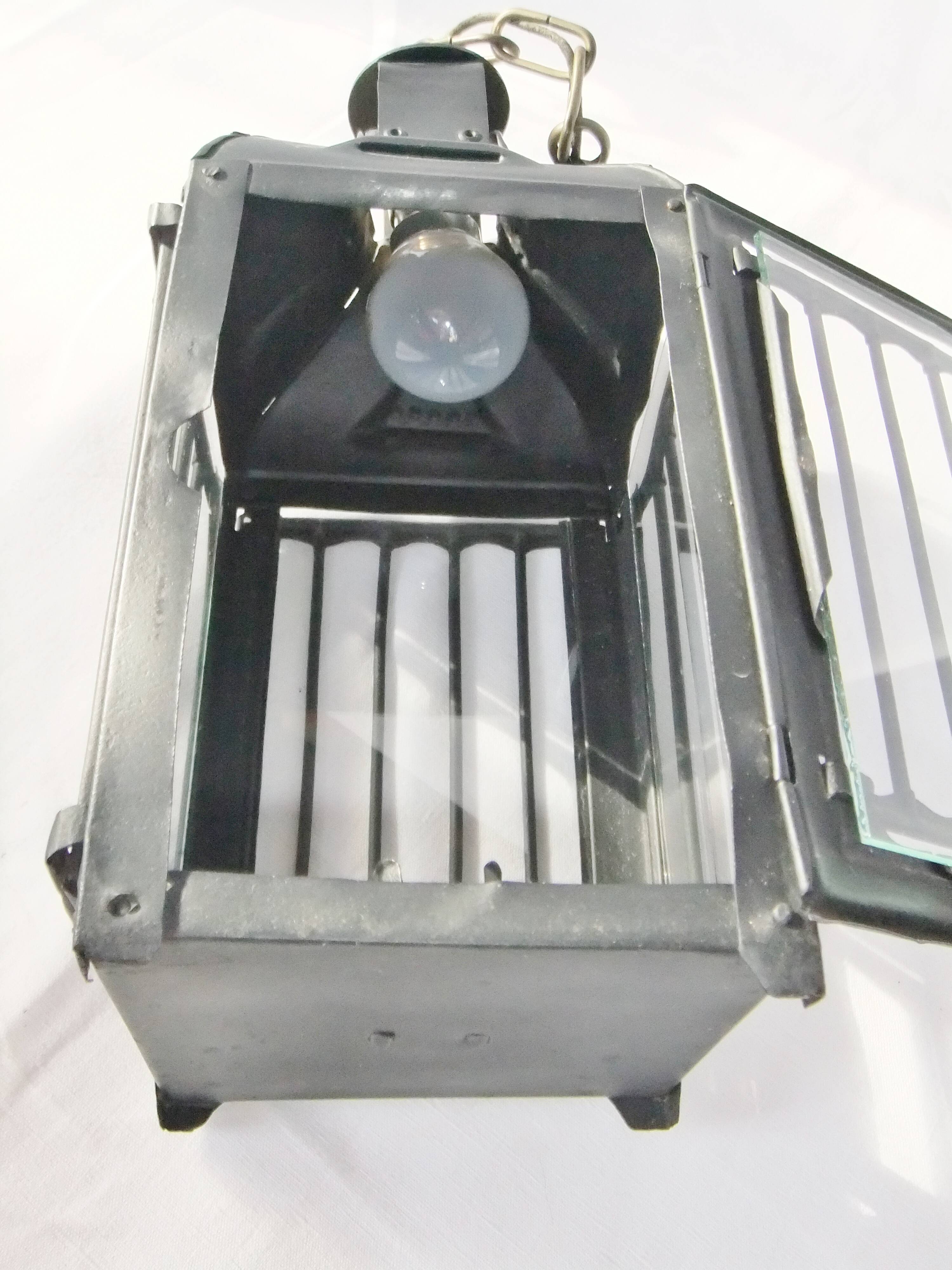Old chandelier hanging lantern with candle in sheet metal