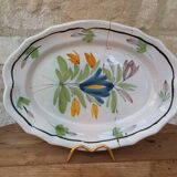 Old oval dish with floral motif called black bottom with staples