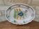 Old oval dish with floral motif called black bottom with staples