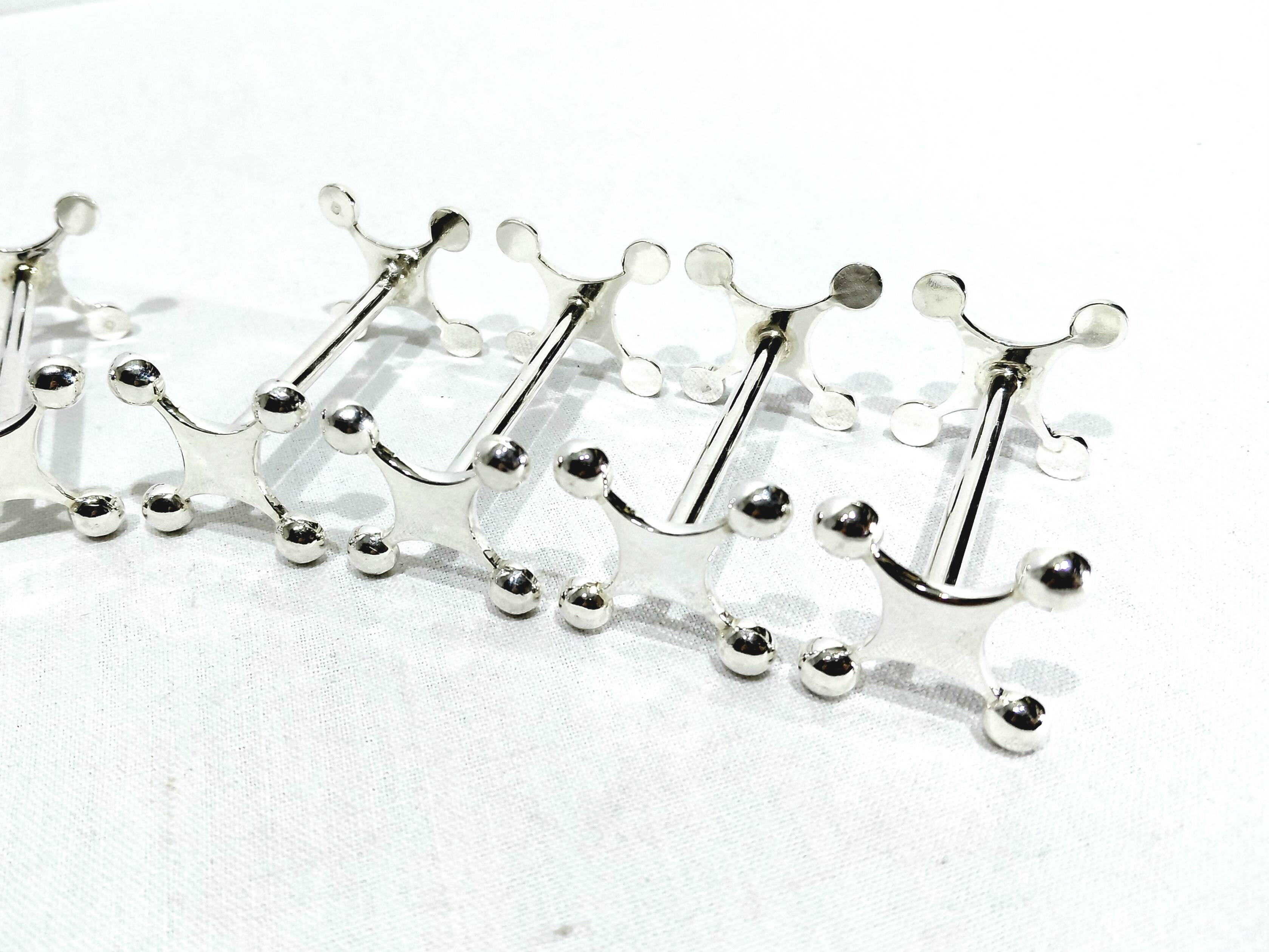 SET OF 12 SILVER-PLATED KNIFE RESTS