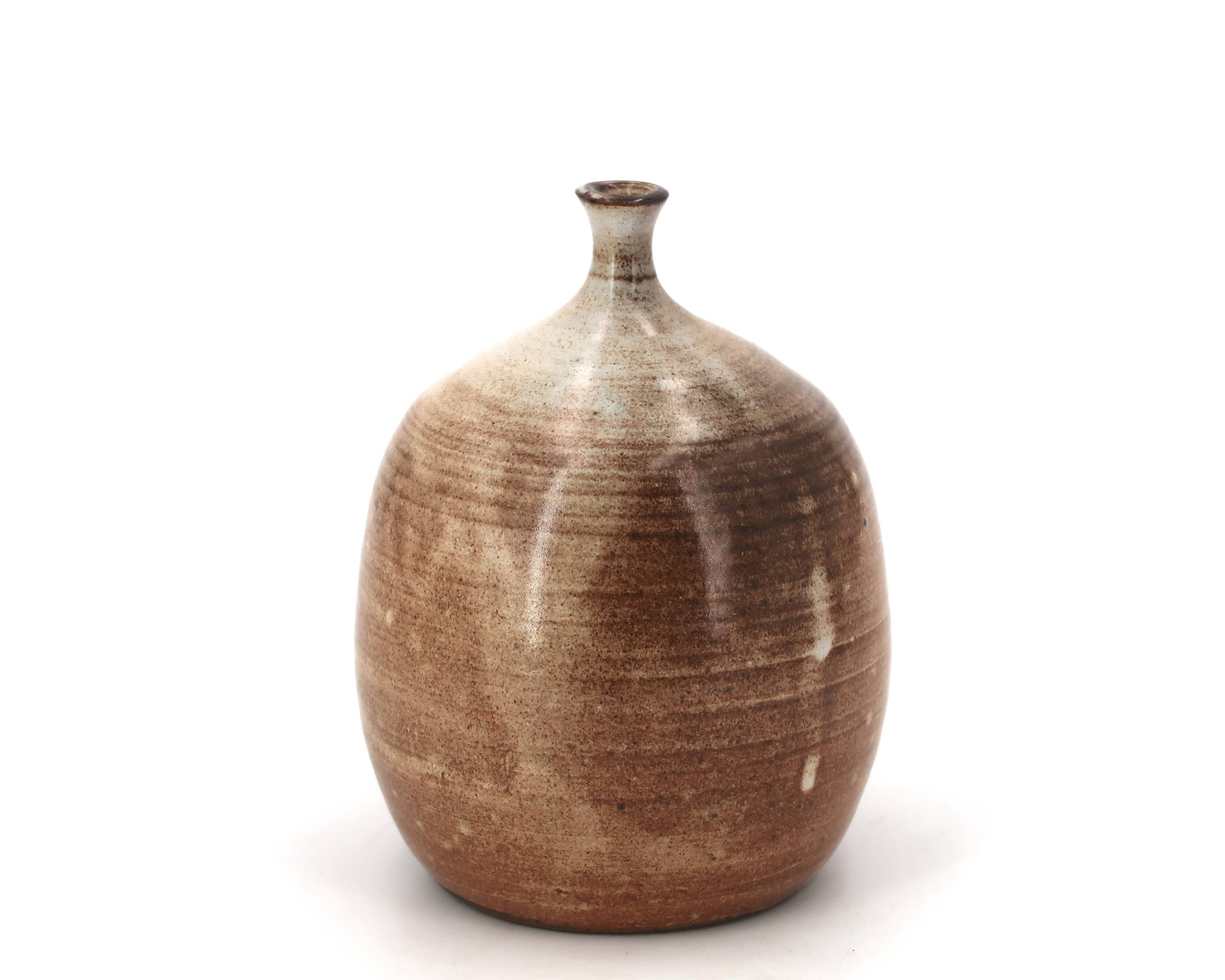 Ovoid vase with a small neck in brown beige ceramic and white drips.