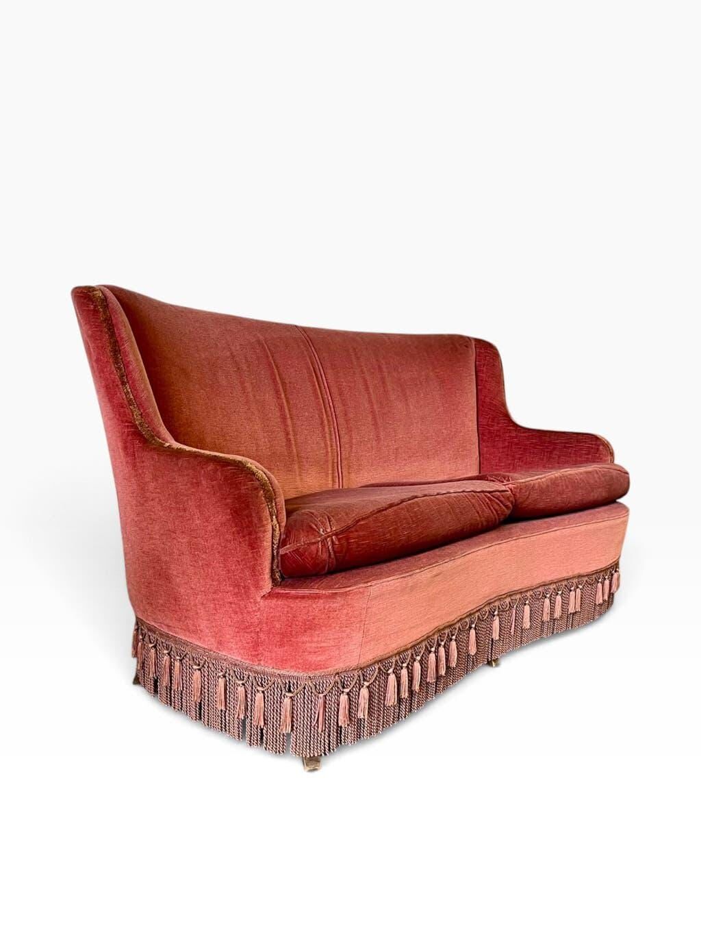Vintage two-seater armchair in powder pink velvet with fringes.