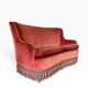 Vintage two-seater armchair in powder pink velvet with fringes.