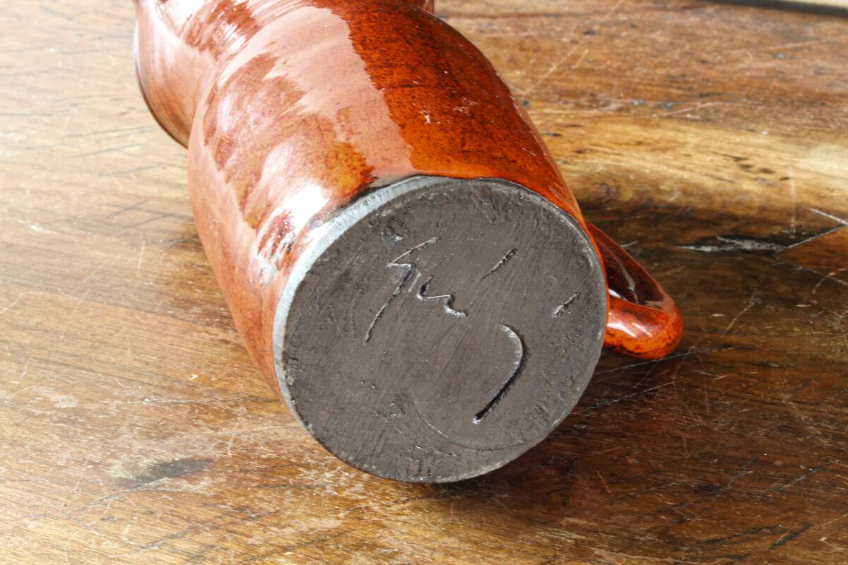 Signed orange ceramic candle holder and jug