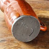 Signed orange ceramic candle holder and jug