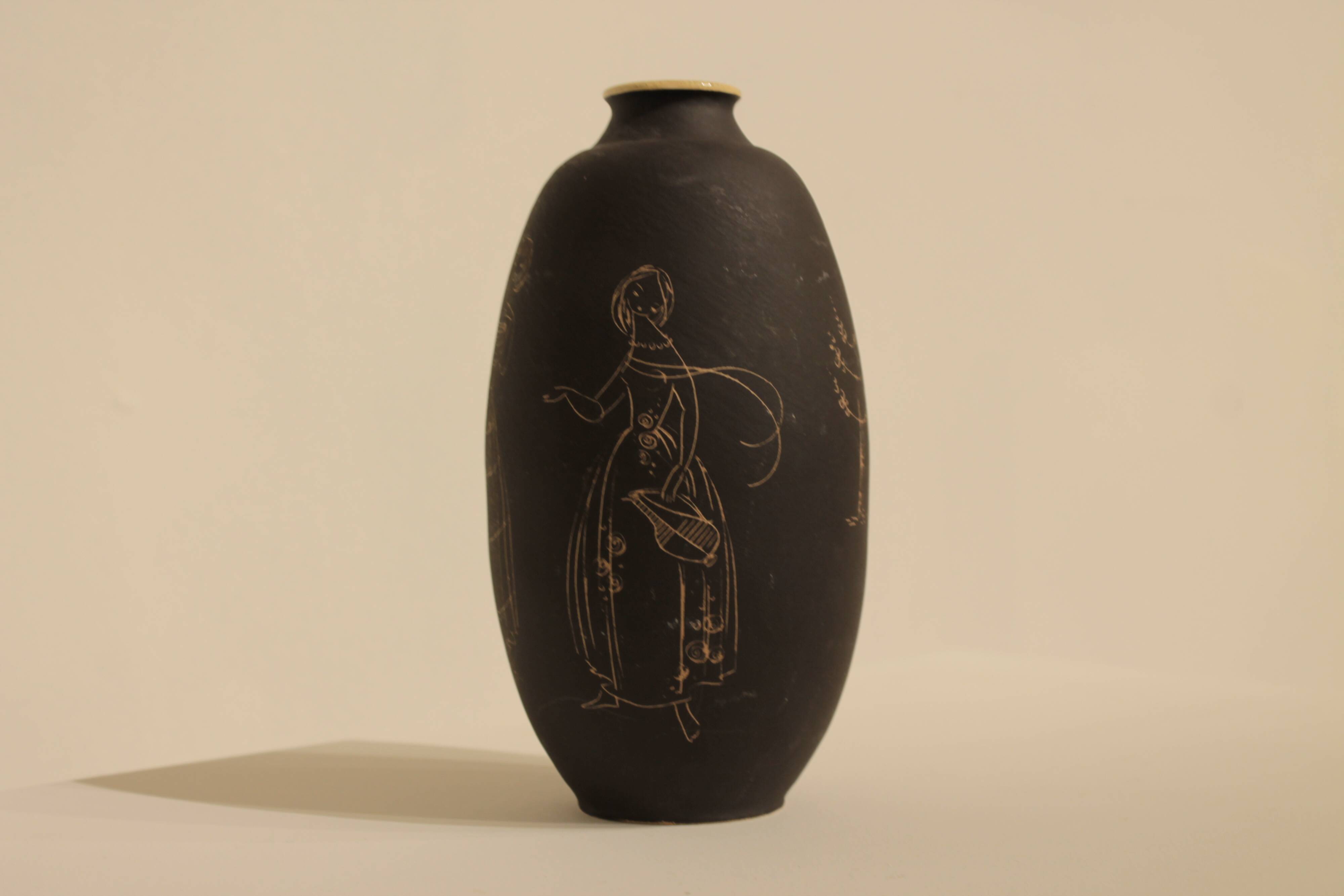 Ceramic vase decorated with women and a tree.