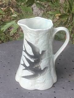 Jade green ceramic barbotine vase with swallows.