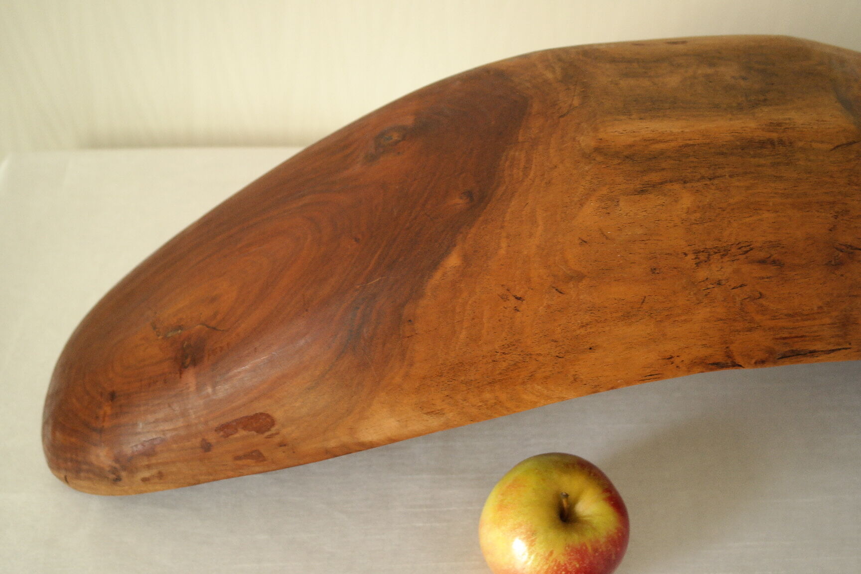 Brutalistic cut in exotic wood boomerang shape