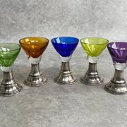 Set of 5 coloured stemmed glasses on silver stems.