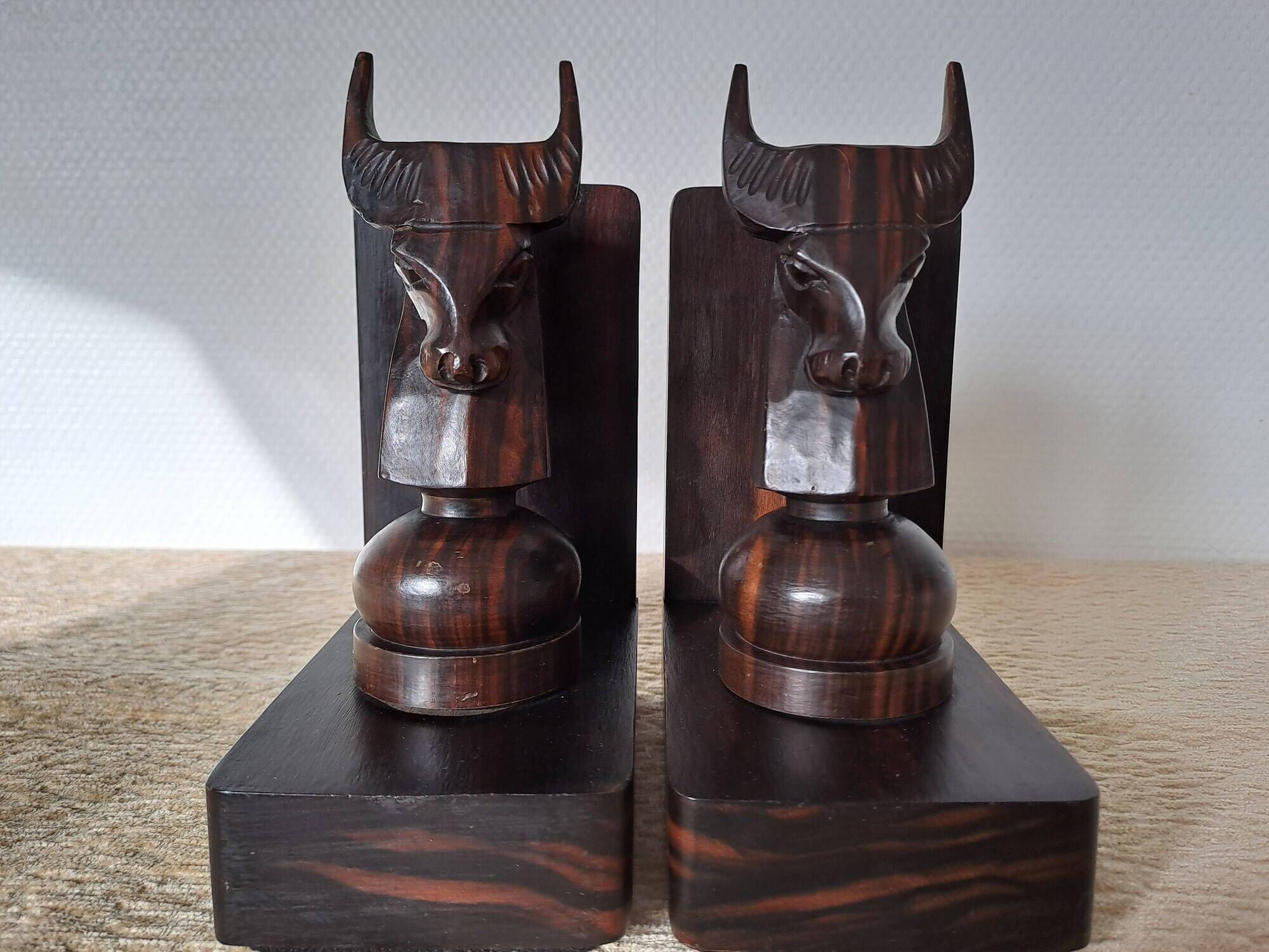 Pair of vintage wooden bookends with stylised horse heads.