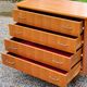 Chest of drawers from the 50s-60s in golden mahogany 4 drawers feet bobbin