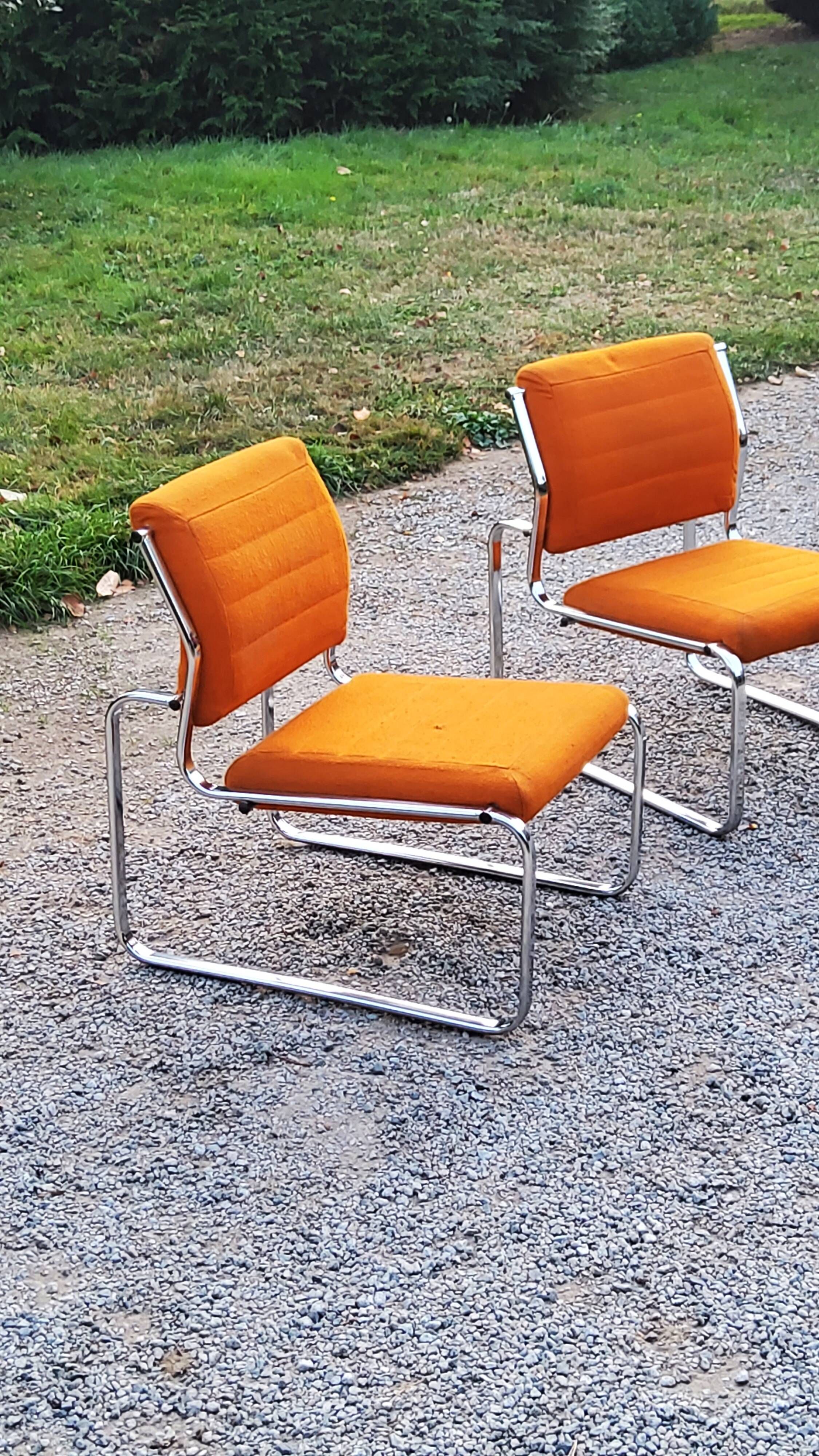 Pair of designer armchairs in orange fabrics and chrome tubes from the 70s