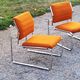 Pair of designer armchairs in orange fabrics and chrome tubes from the 70s