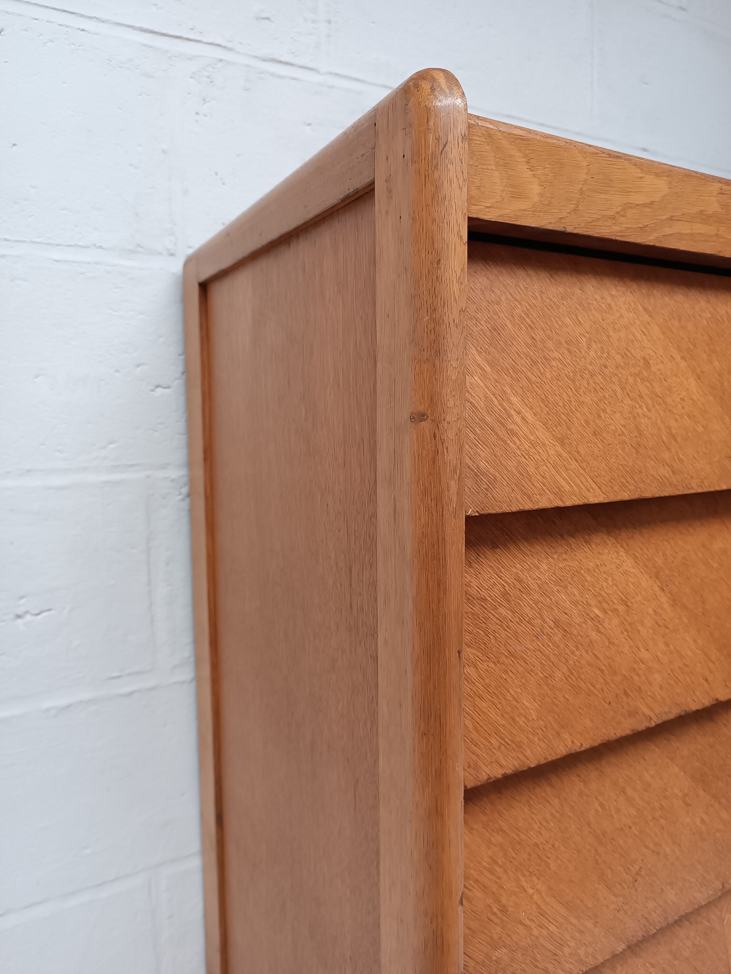 High wooden chest of drawers in the 50s