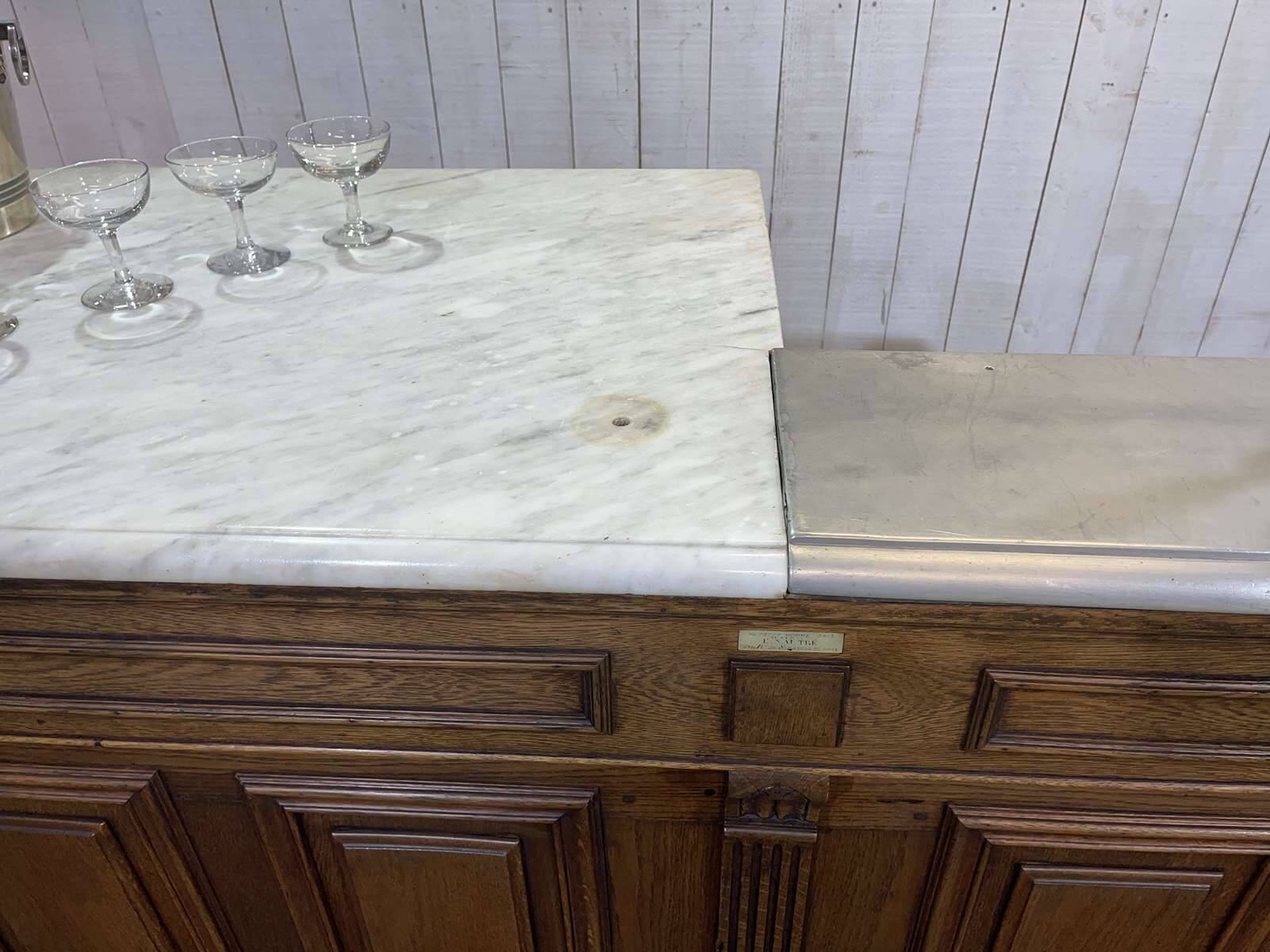 Bar counter in oak, zinc, and white marble from the early 20th century.