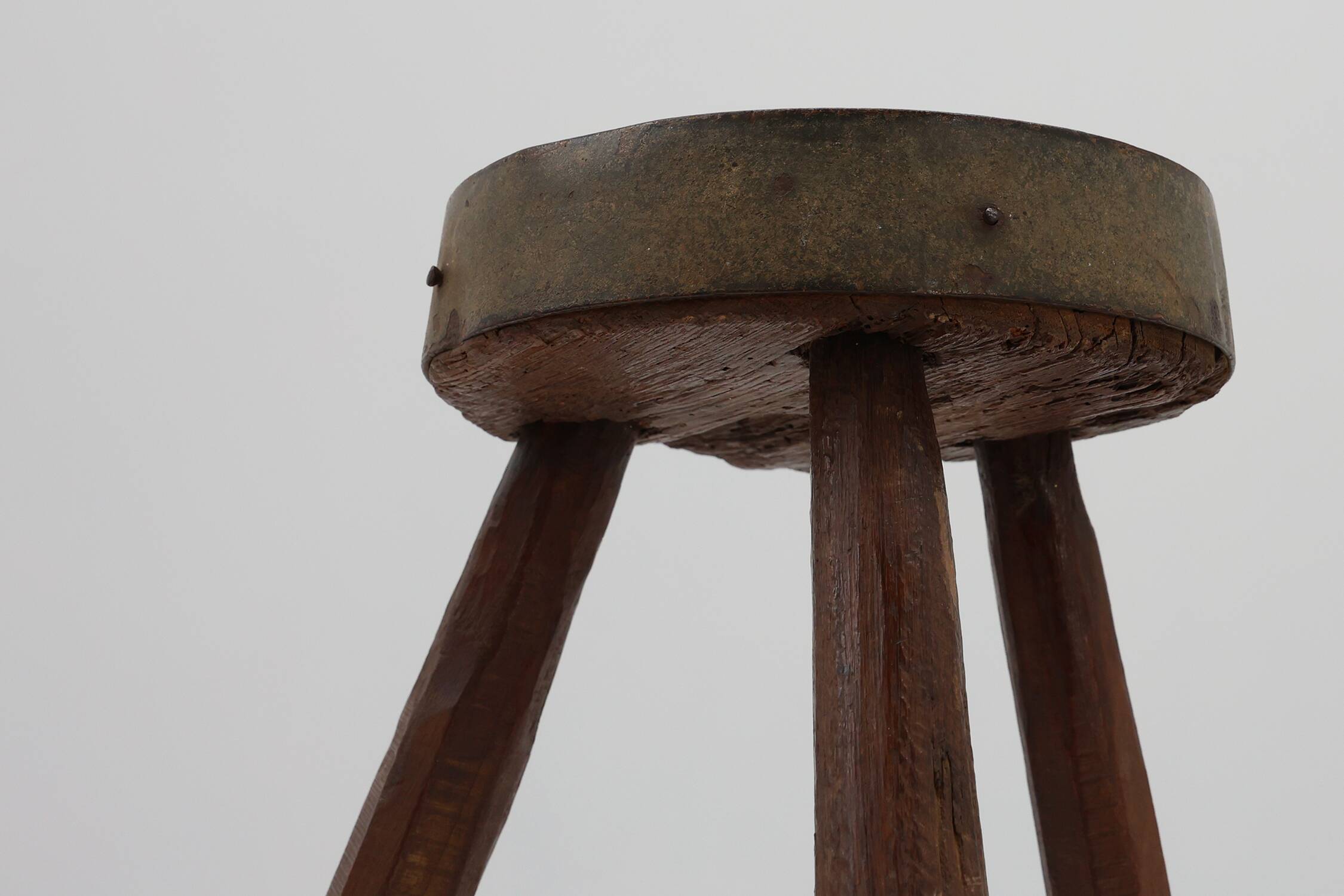 Brutalist French 1850s solid oak tripod stools with metal rim, set of 4