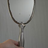 Antique hand mirror with stitched glass