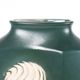 A tall ceramic vase glazed with dark green colour