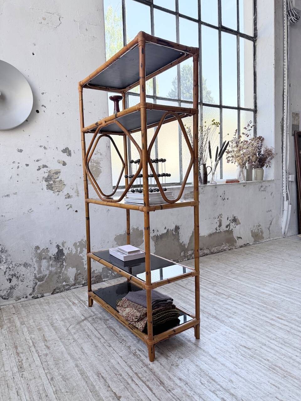 Rattan bookshelf and black glasses