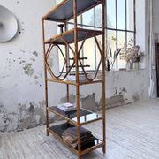Rattan bookshelf and black glasses