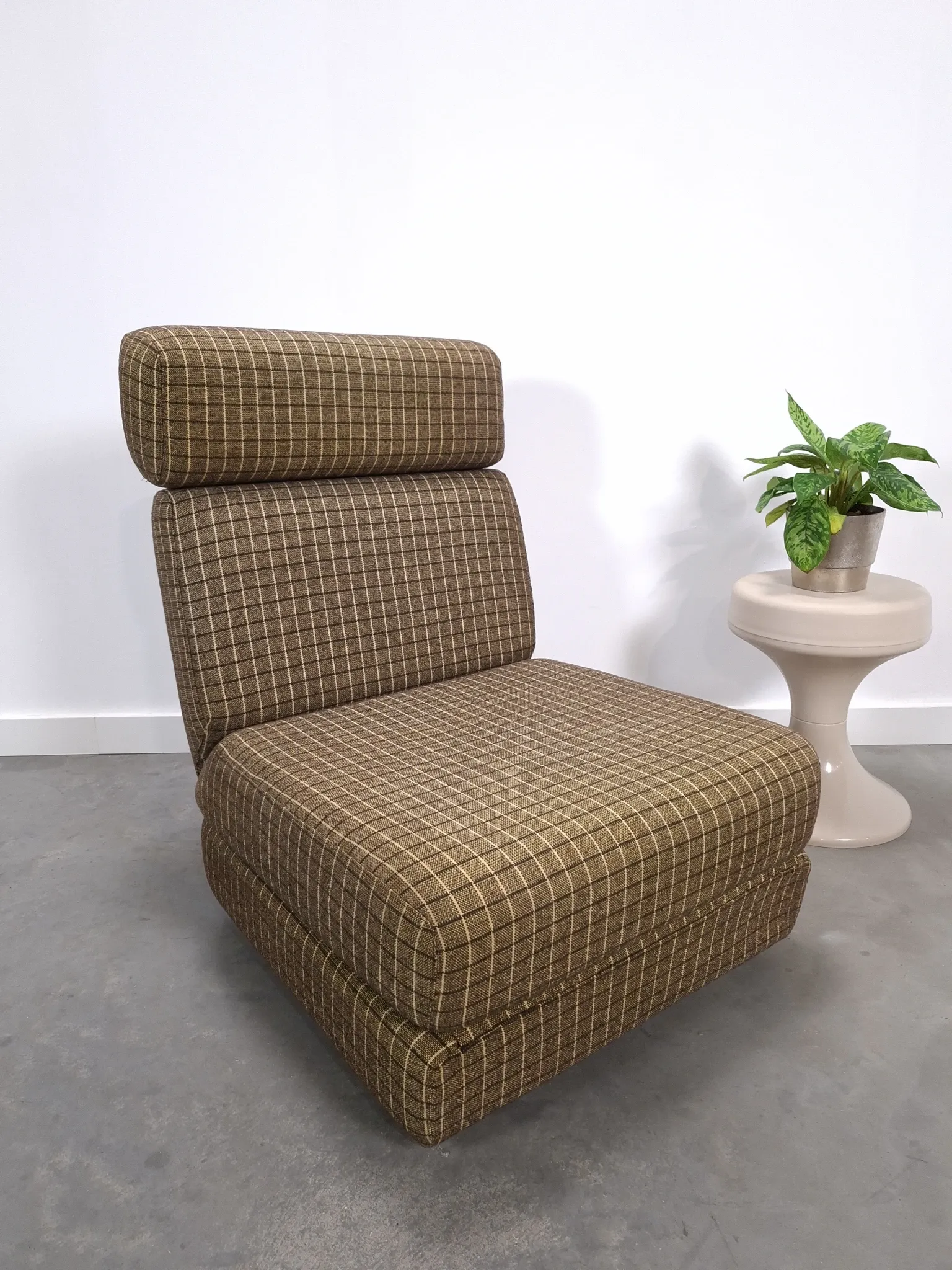 Vintage pull-out sofa bed, brown checked lounge chair with chrome.