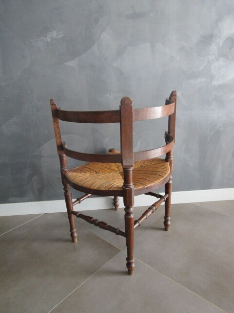 Old straw corner armchair