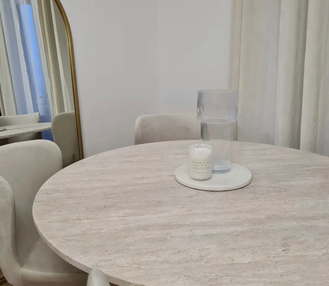 Omega circular dining table in natural travertine