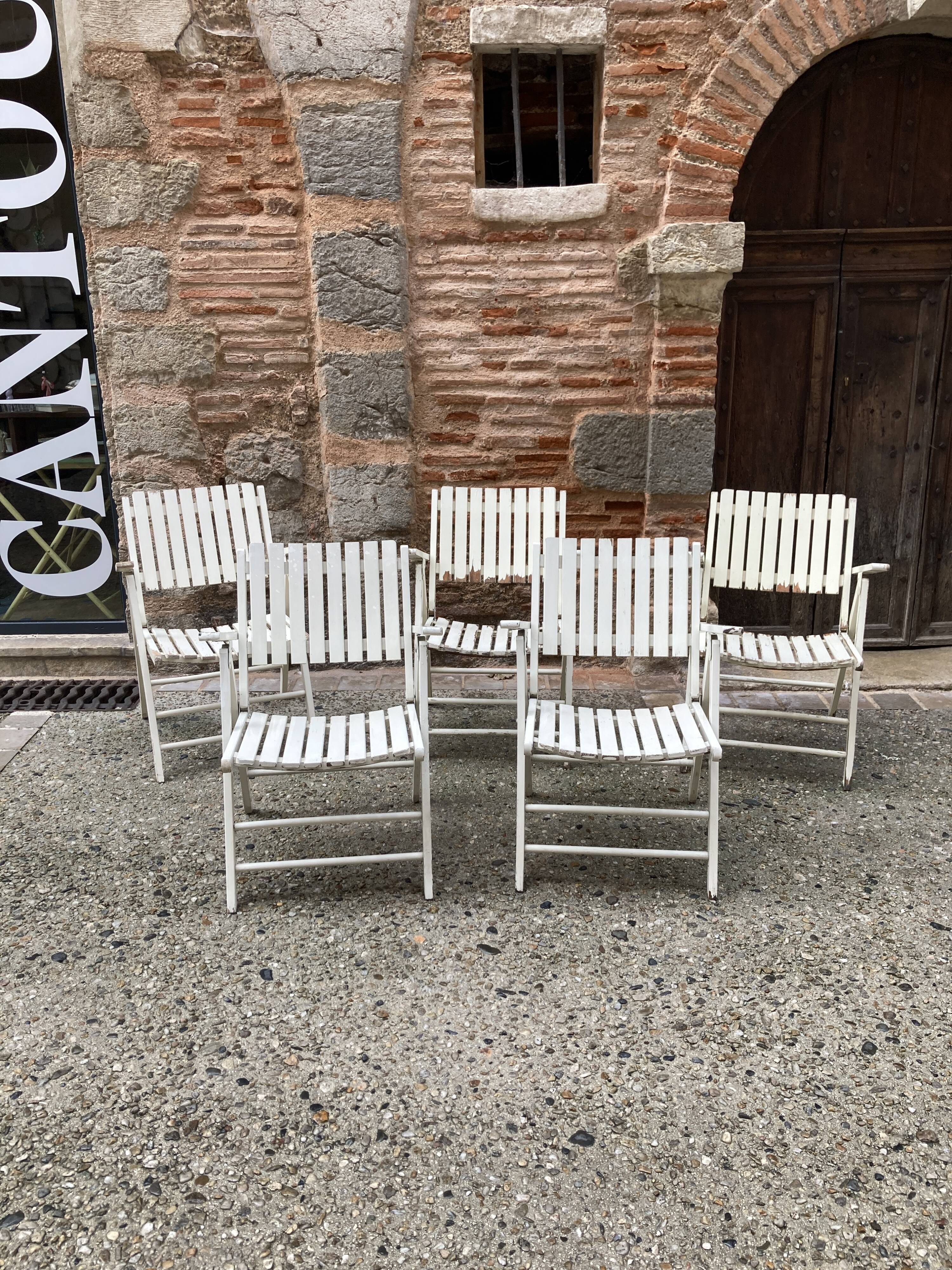 Five wooden garden armchairs