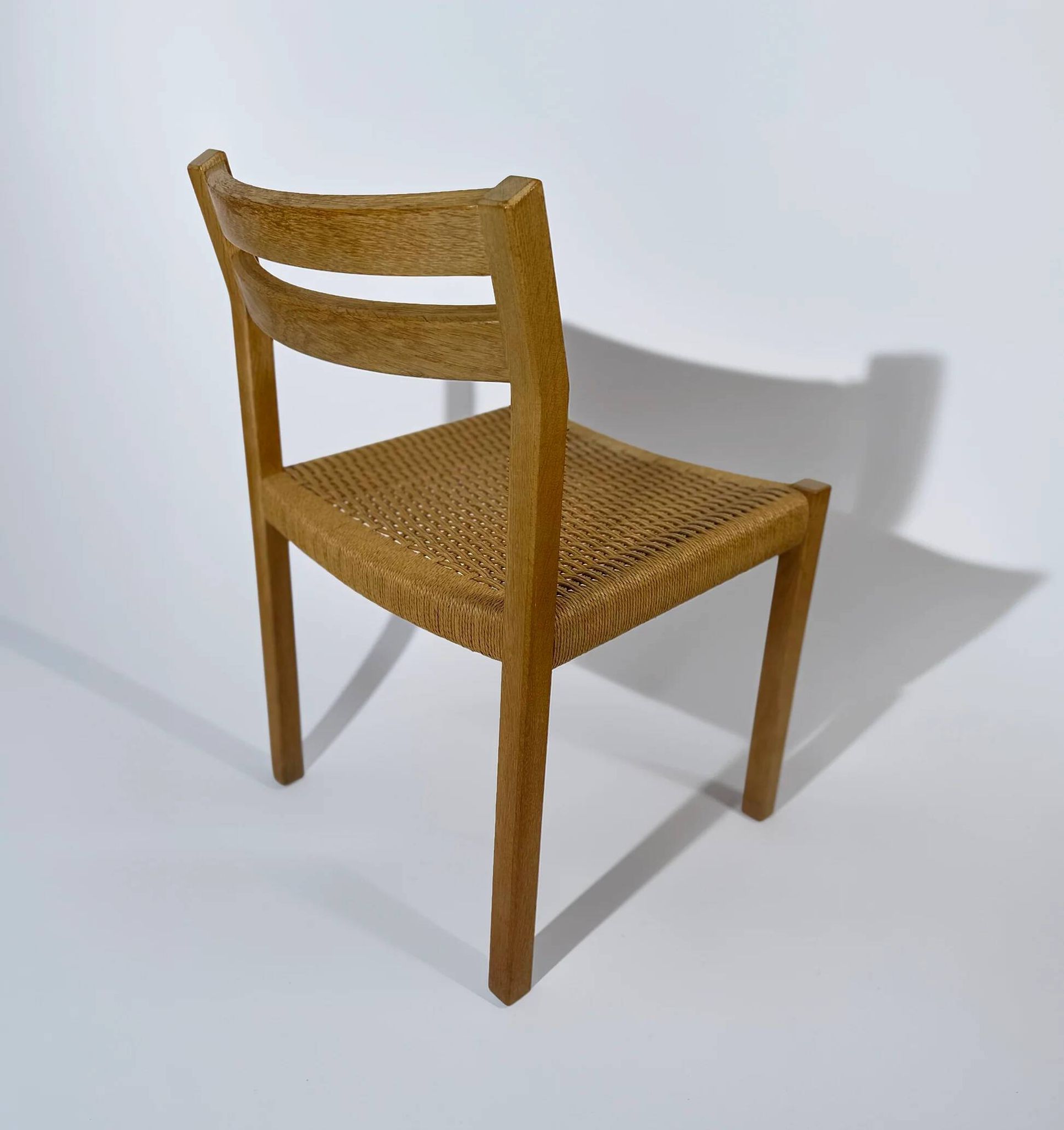 Dining chairs J.H. Møller model 401 in oak with original Danish cord — Denmark, 1970s
