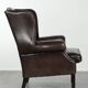 Dark brown cowhide Chesterfield wingback armchair in classic English style