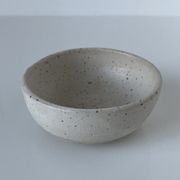 Meeting of three artist's ceramic objects including two pots and a cream covered bowl