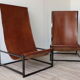 Pair of vintage armchairs in stretched leather and metal structure