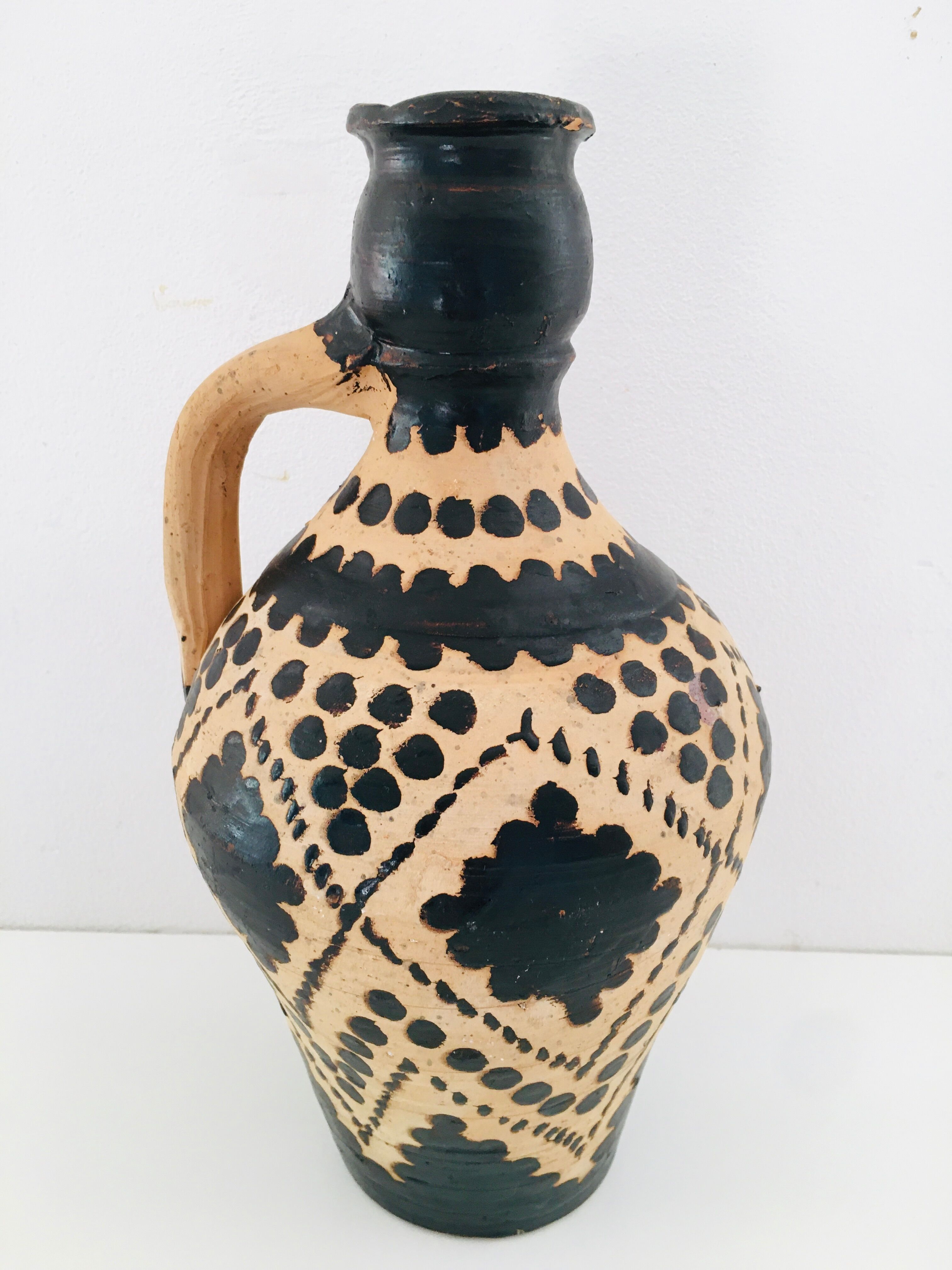 Raw and black terracotta jug