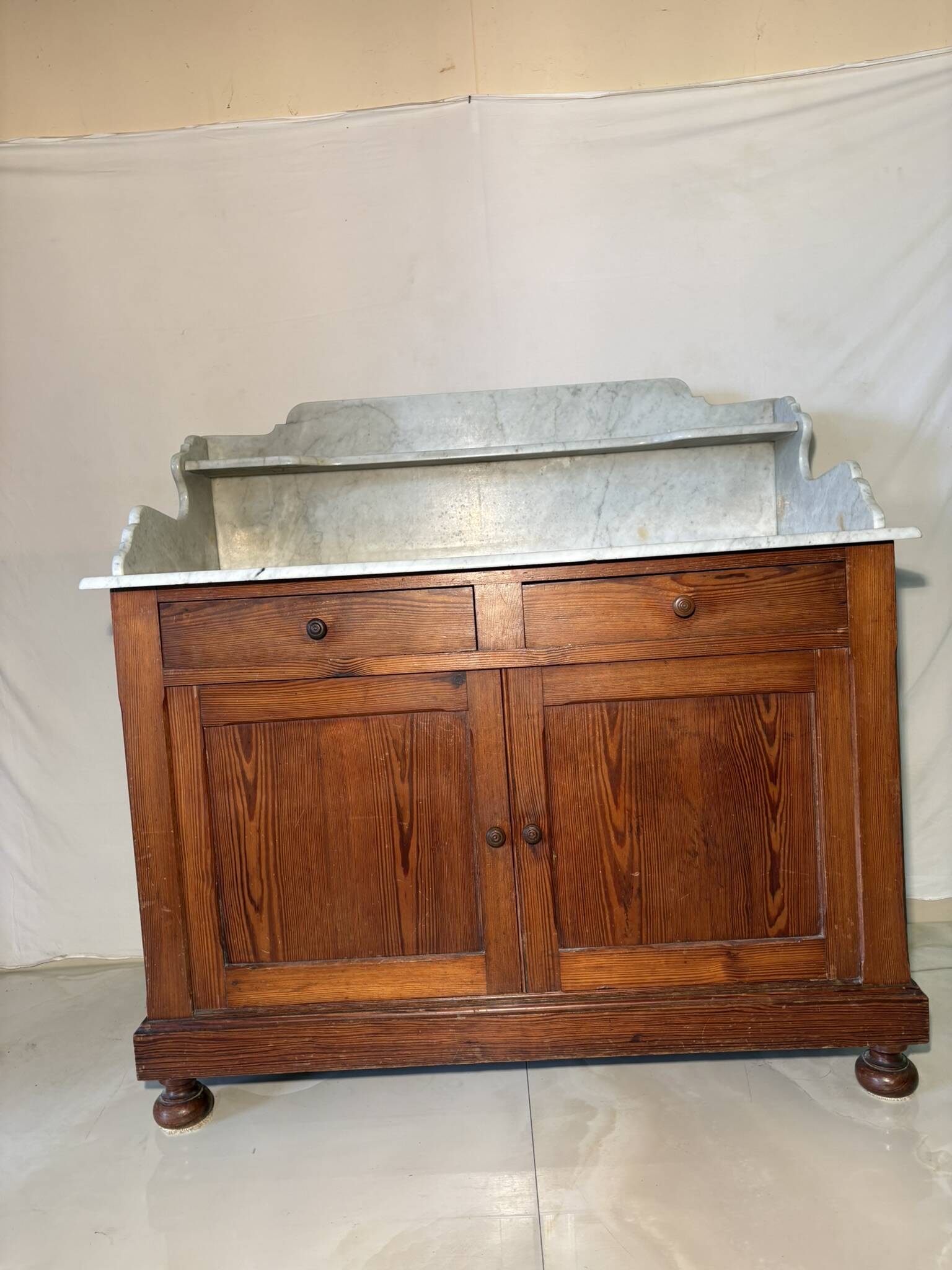 Antique wood and marble kitchen sideboard with carved backsplash