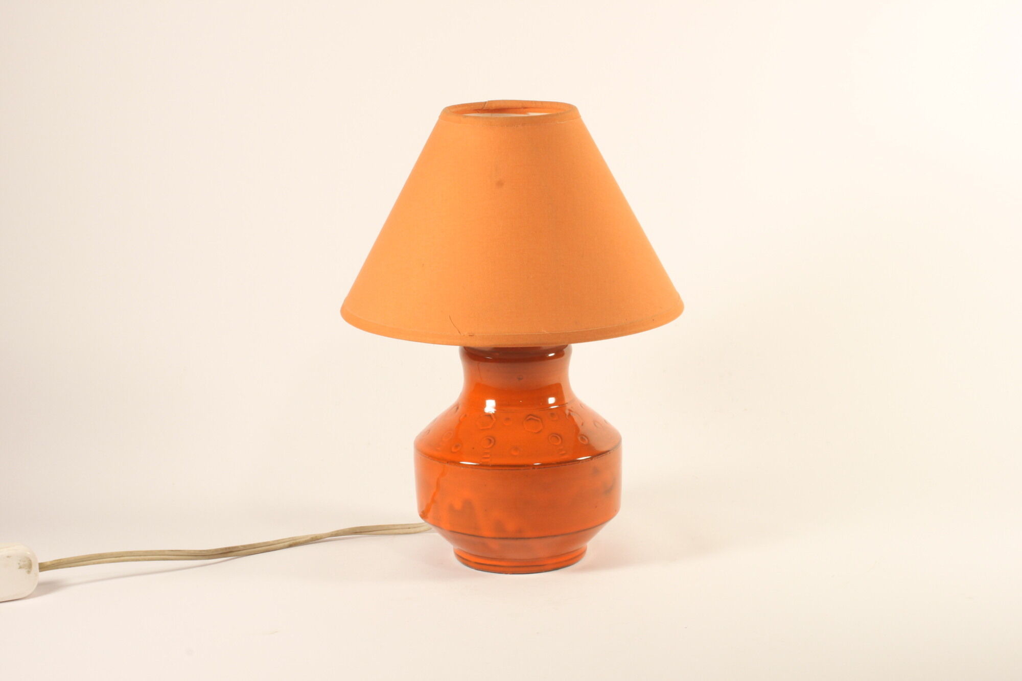 Orange ceramic table lamp with geometric imprints, 1970s.