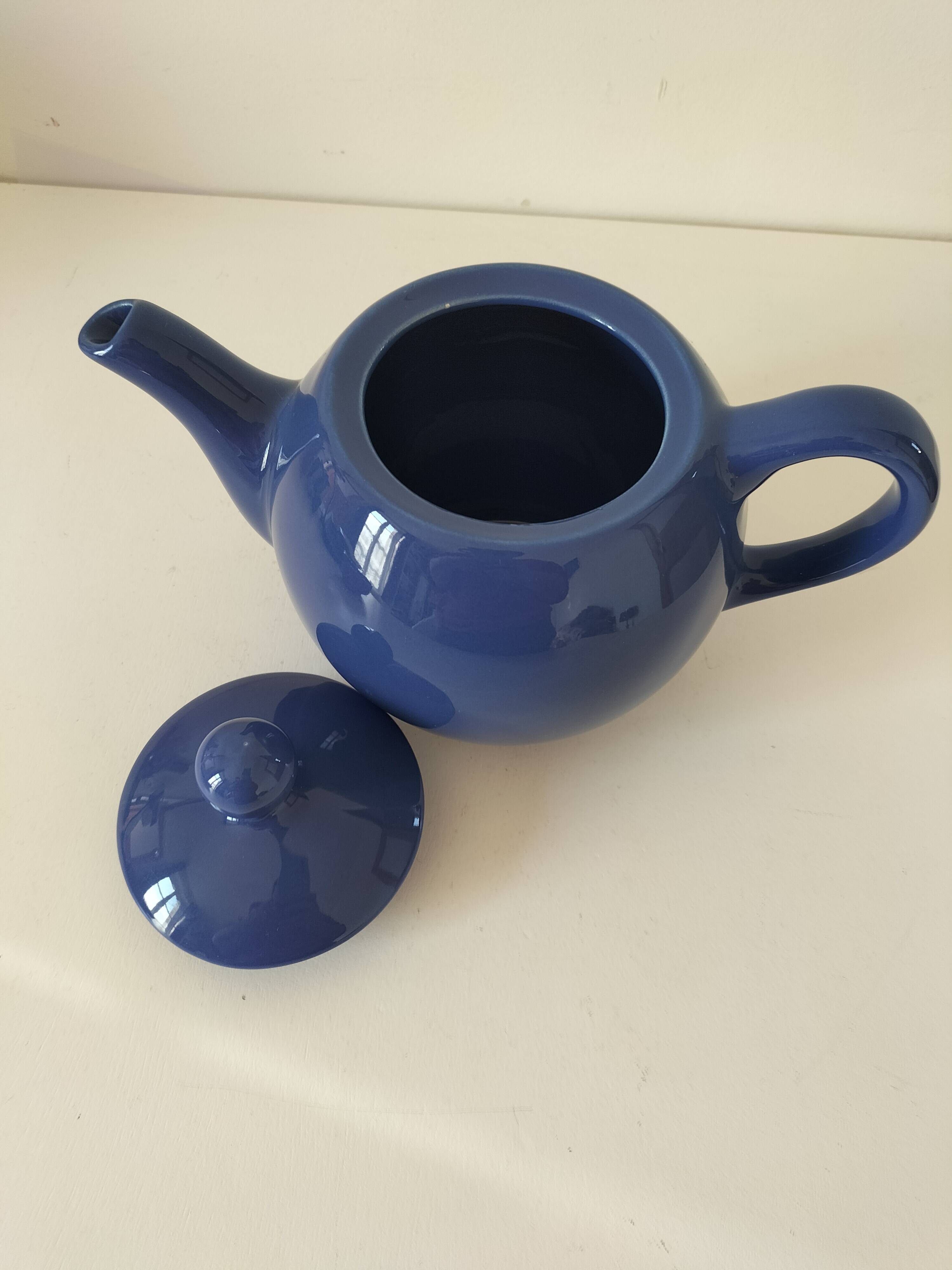 Vintage deep blue teapot, minimalist round shape.