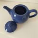 Vintage deep blue teapot, minimalist round shape.
