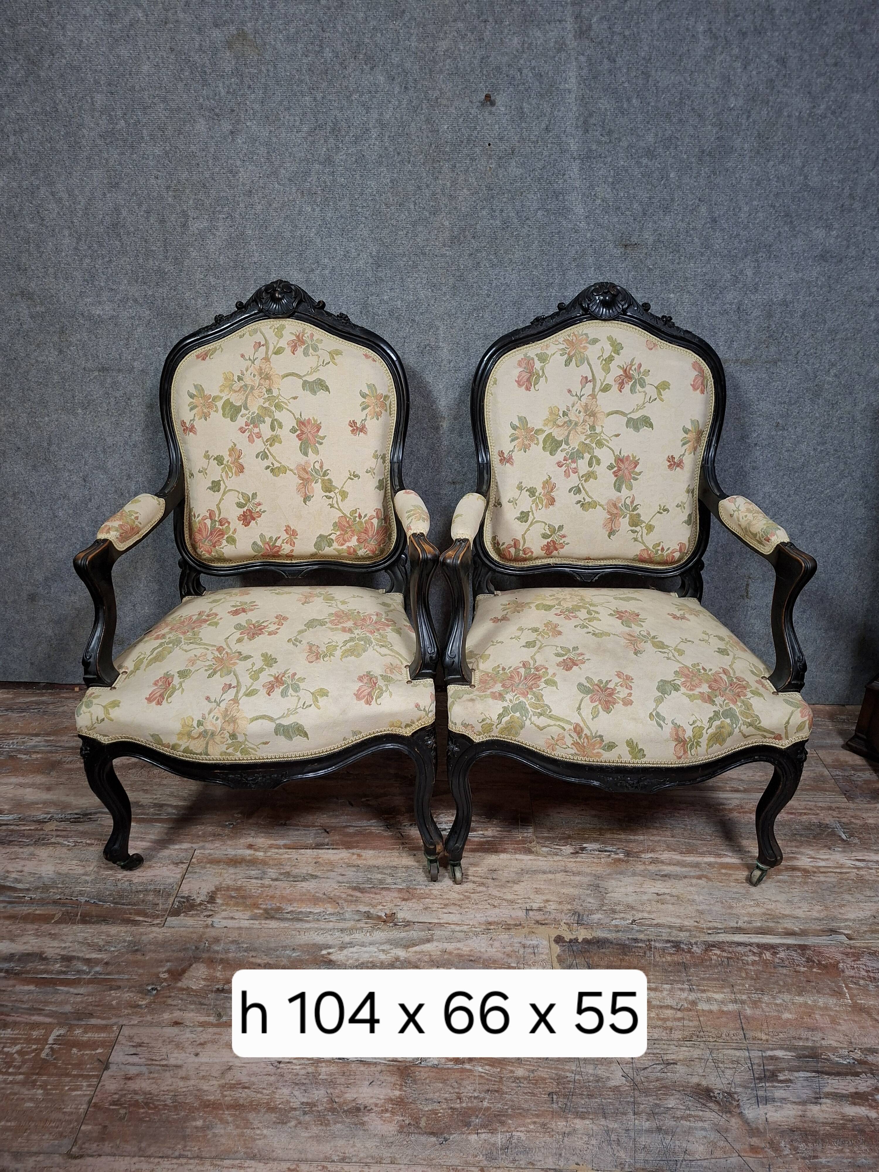 pair of Louis XV style armchairs, in moulded and carved wood, lacquered black