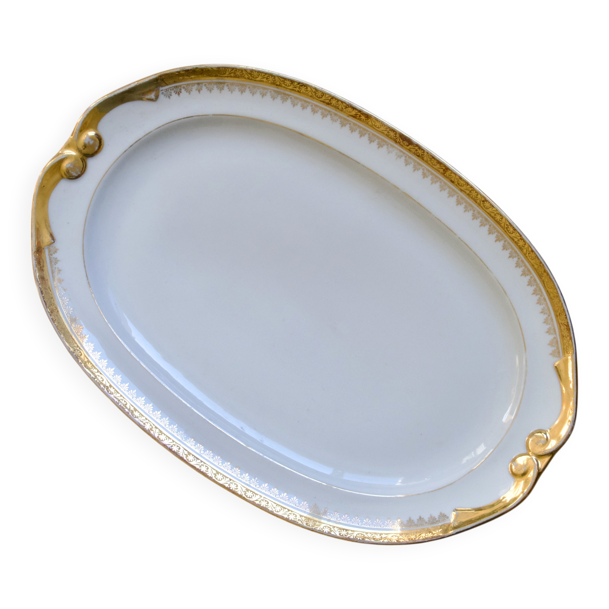 Large oval dish with gold trim in Limoges porcelain by Peconnet.