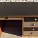Large wooden desk with 5 drawers and a black faux leather top - Completely revamped.