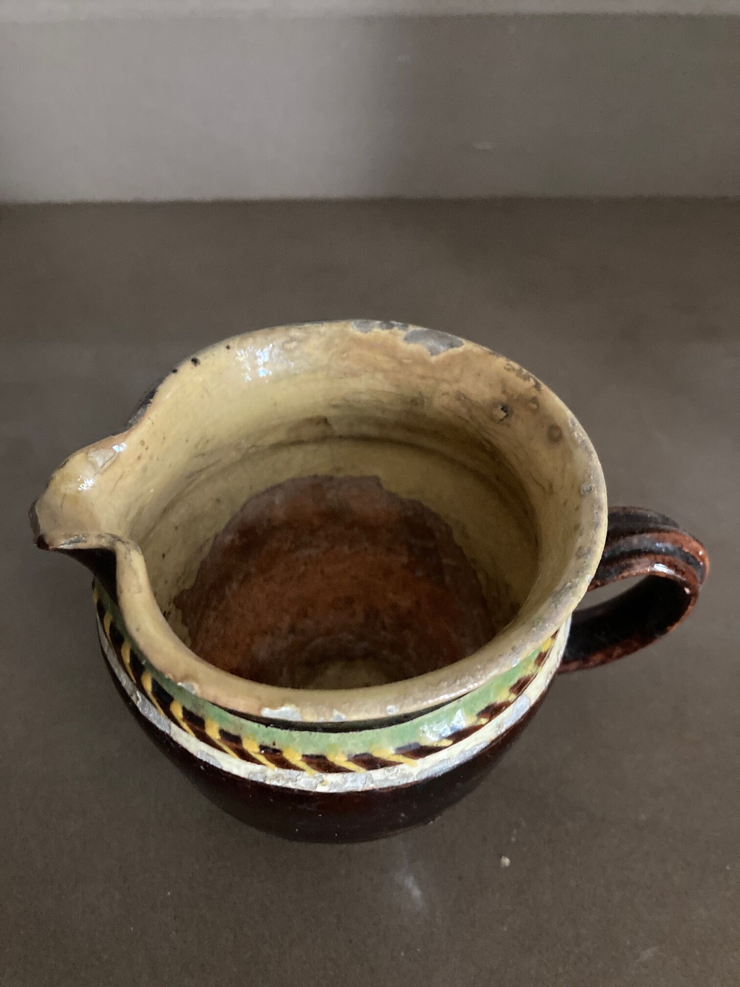 Antique pottery milk jug