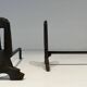 Pair of Modernist Andirons in Cast Iron with Openwork Uprights and Tripod Bases