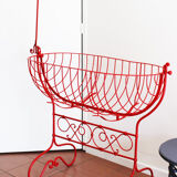 Baby cradle in red wrought iron