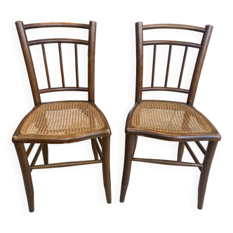 Pair of antique caned and wooden chairs from the 1900s.