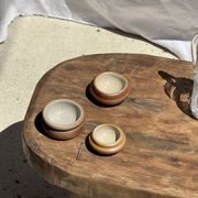 Small stool, oval solid teak side table with curved legs in wabi-sabi style.