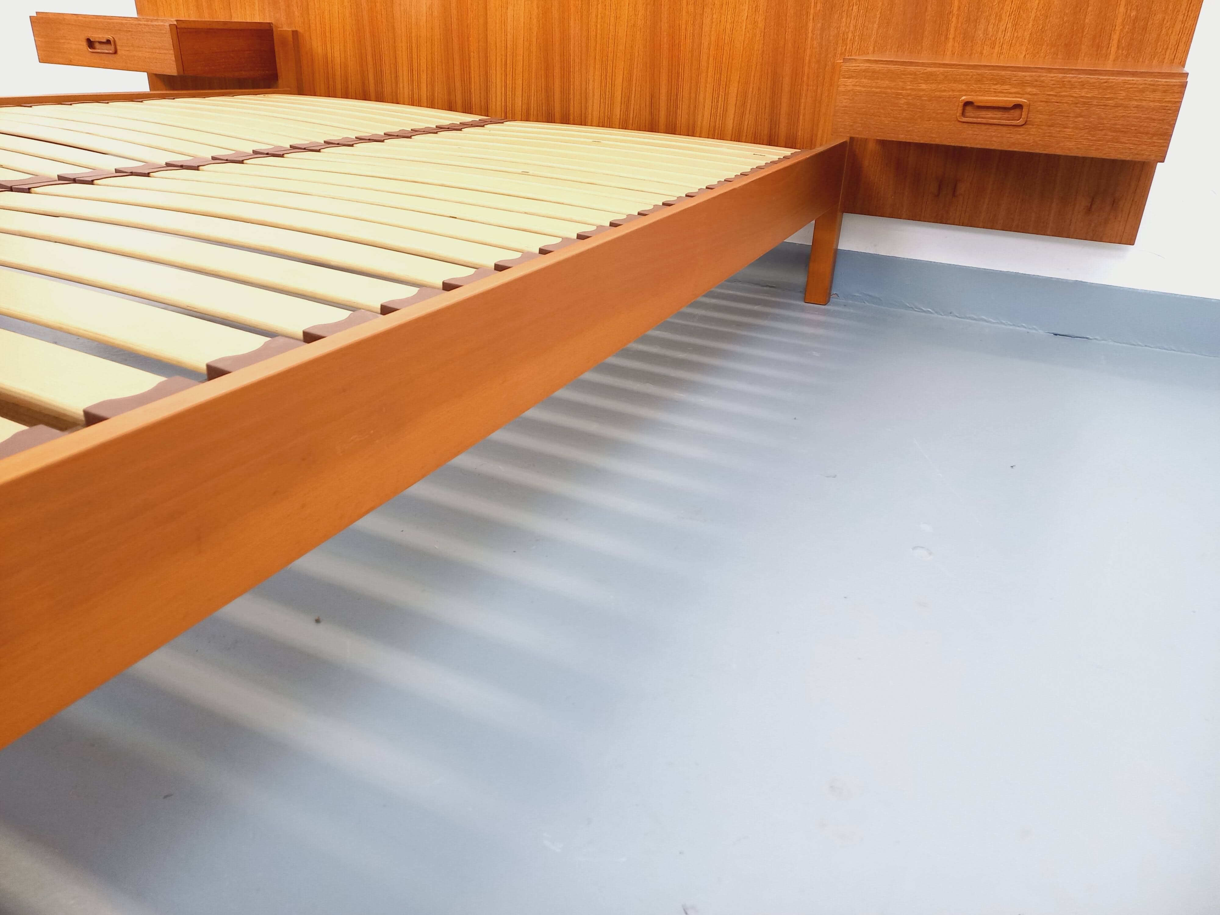 Double bed vintage Scandinavian in teak from the 1960s with integrated bedside tables.
