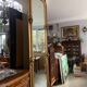 French palace mirror with bow and lion heads, gilded frame.