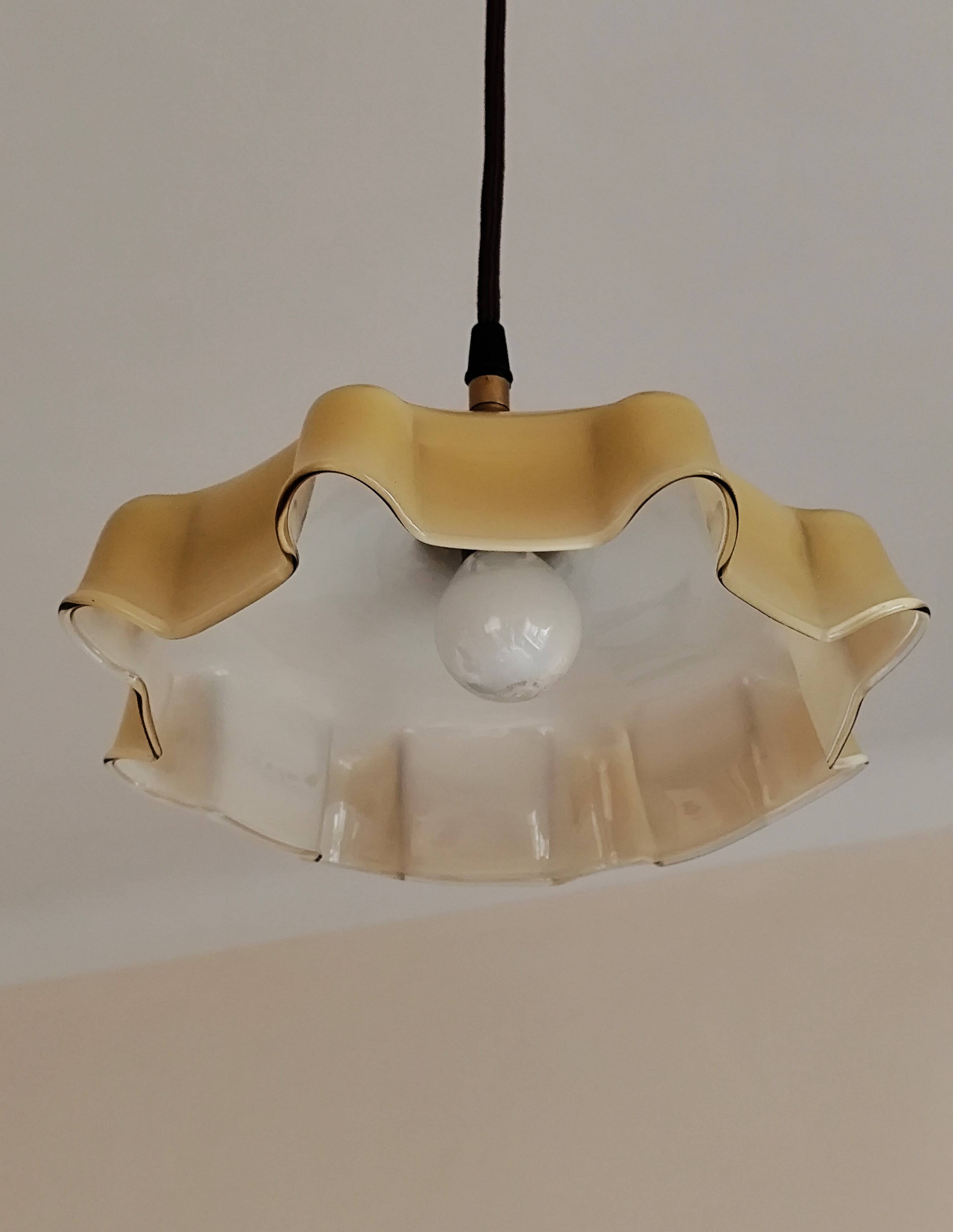 Electrified suspension with a frosted opaque glass disc shade.