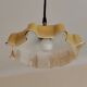Electrified suspension with a frosted opaque glass disc shade.