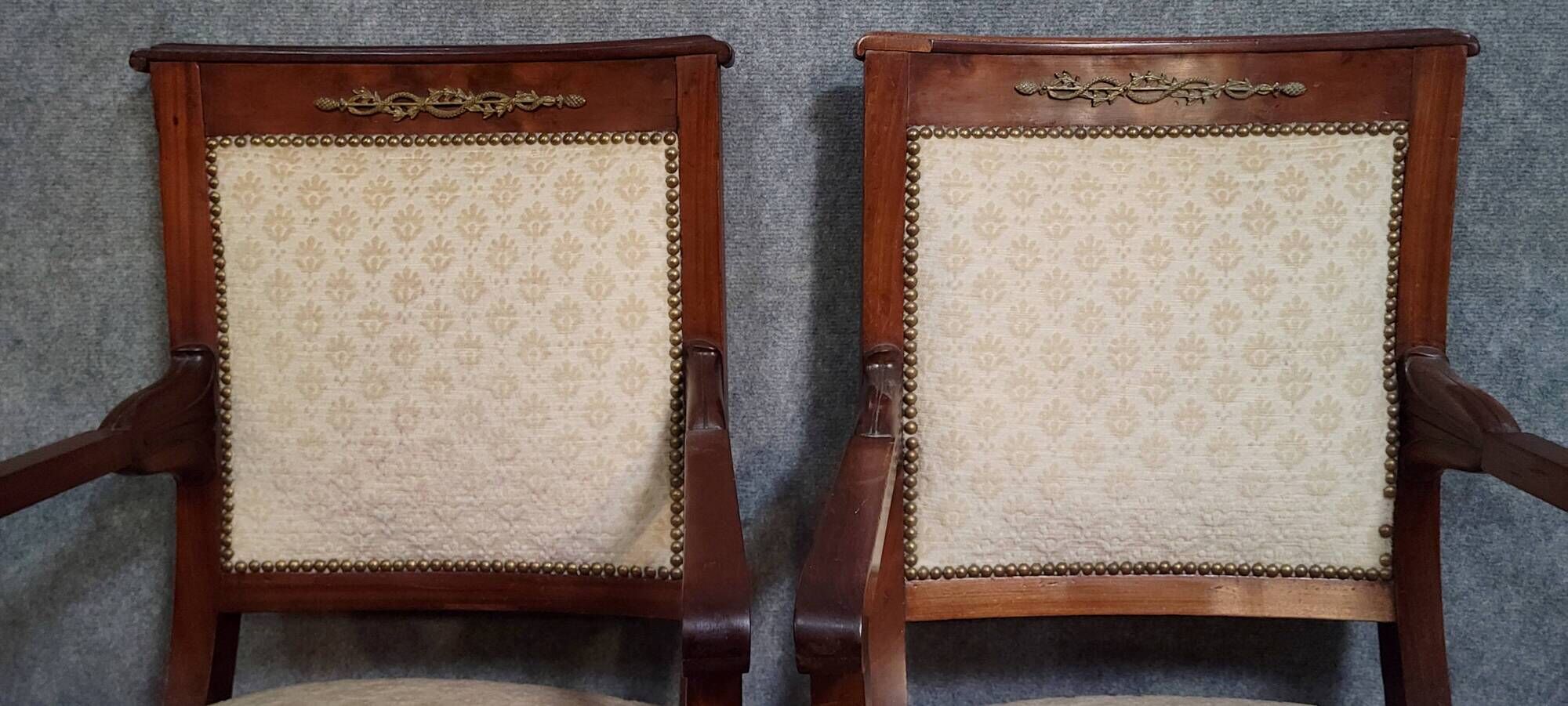Pair of Empire period armchairs, in mahogany and gilded bronze.